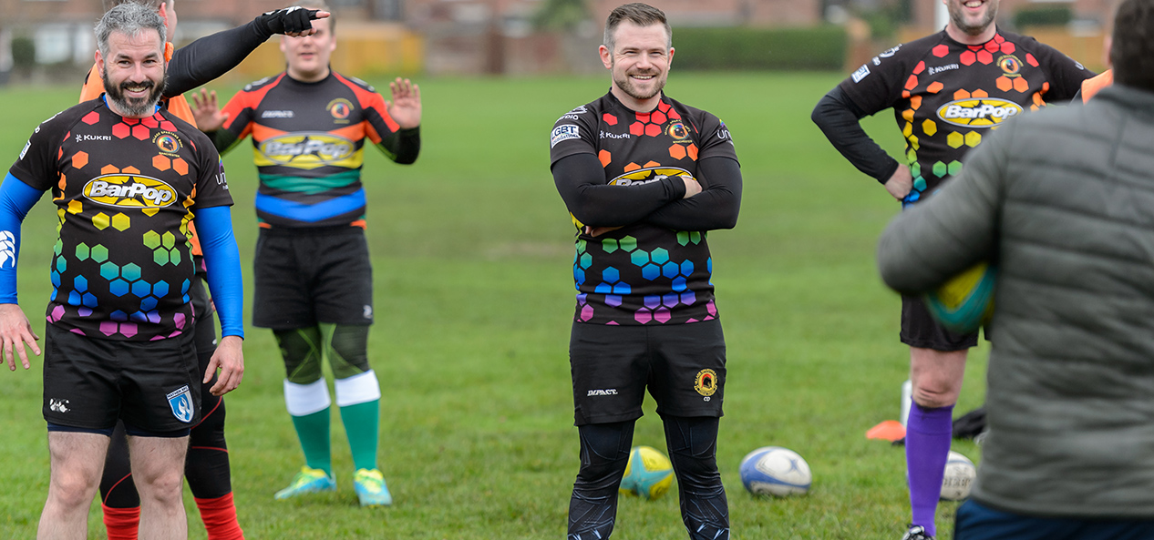 Village Spartans Rugby Club players relax during a session in the park