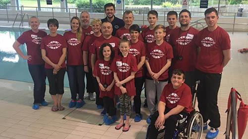 Members of the See My Voice group pose for a photo by the side of a swimming pool