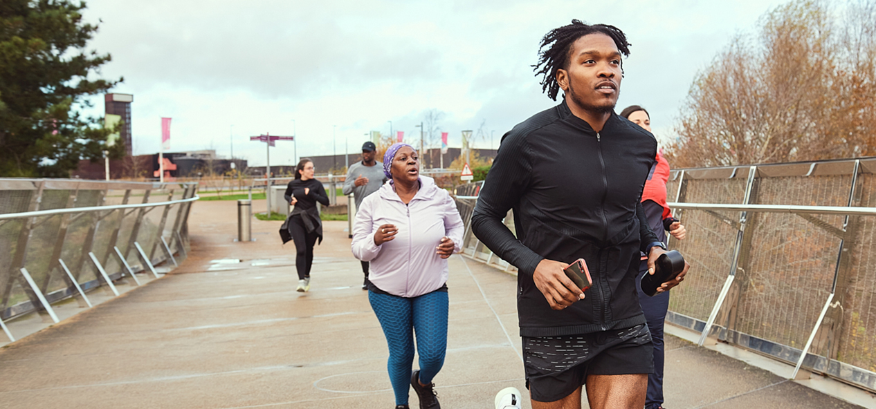 A group of people, run in a park