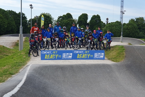 Children and coches from Peckham BMX Club pose for a picture on the track