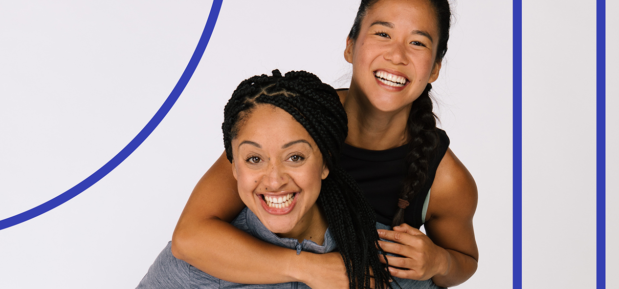 A Studio You instructor climbs on the shoulders of another instructor