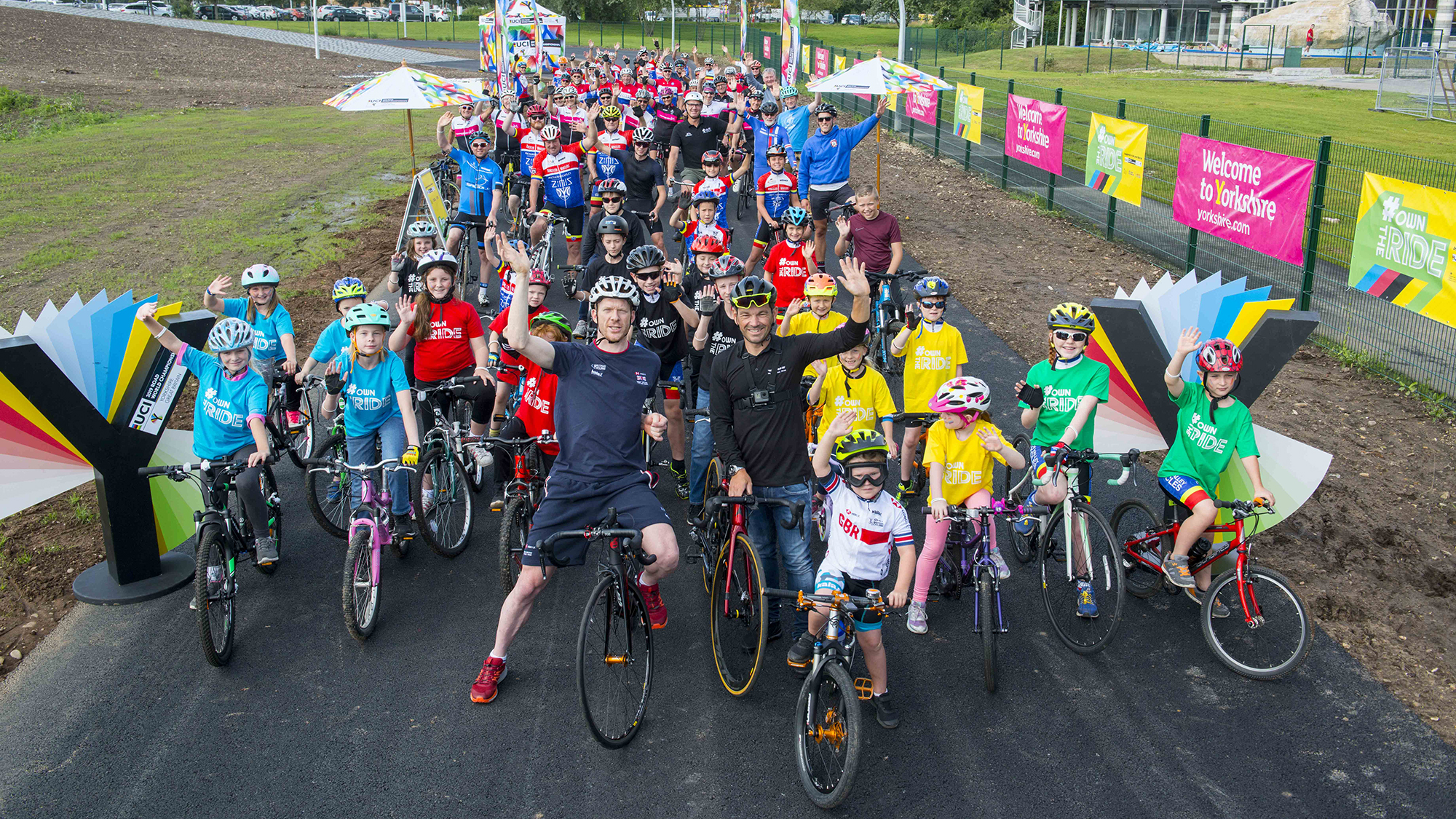 group of cyclists waving