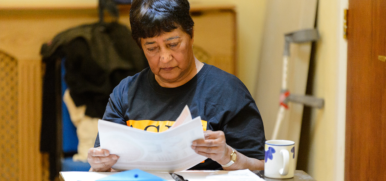 A woman looking at some paperwork.