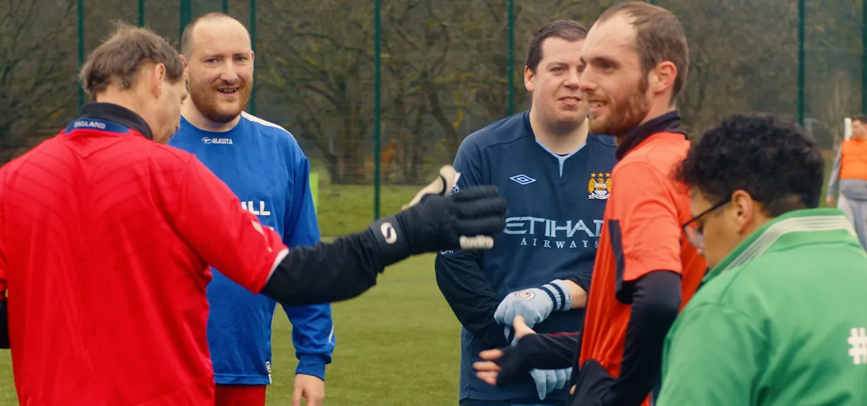 Members of Blokes United talk to each other on the pitch