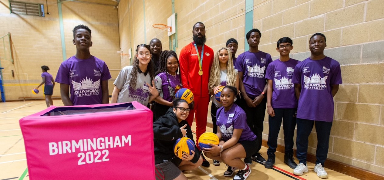 Orlan Jackman poses with members of the Guardian Ballers as they receive kit from the Birmingham 2022 Commonwealth Games