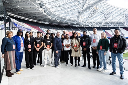 Winners and judges of the Go! London Young Entrepreneurs competition pose for a photo at London Stadium