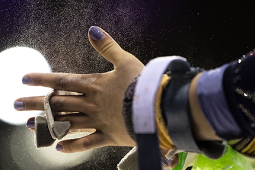 A gymnastic adjusts a wrist guard