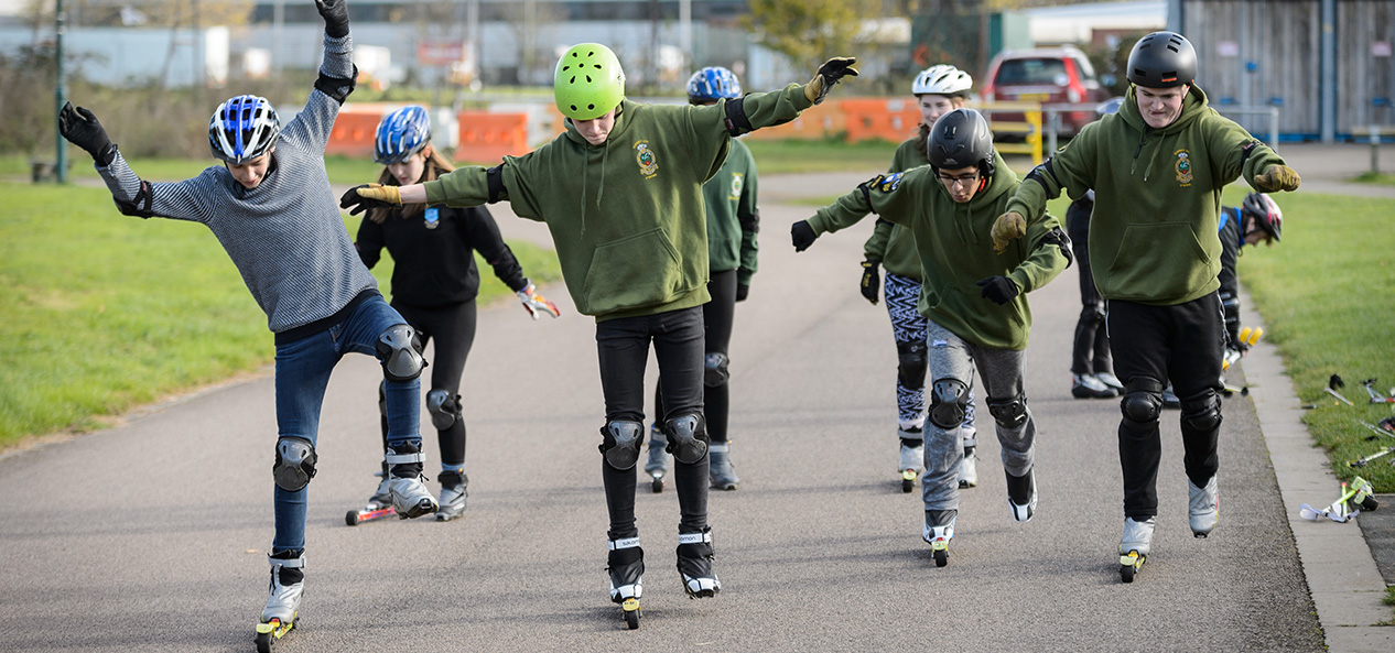 Teenagers try Nordic skiing on roller skis