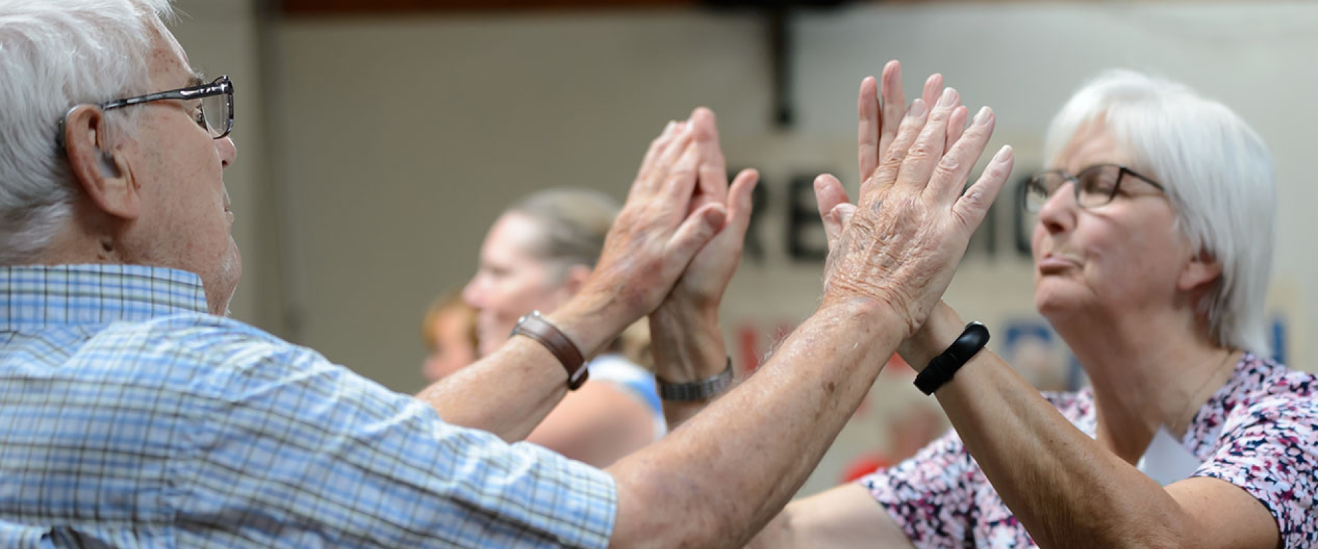 Two pensioners clap hands during a British Gymnastics Love to Move session.