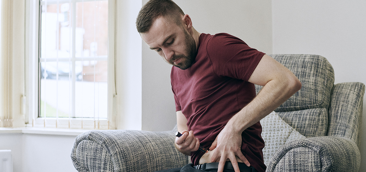 A man using a diabetes pen.