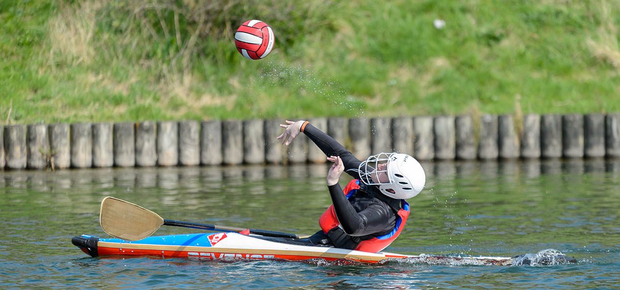 A boy playing canoe polo