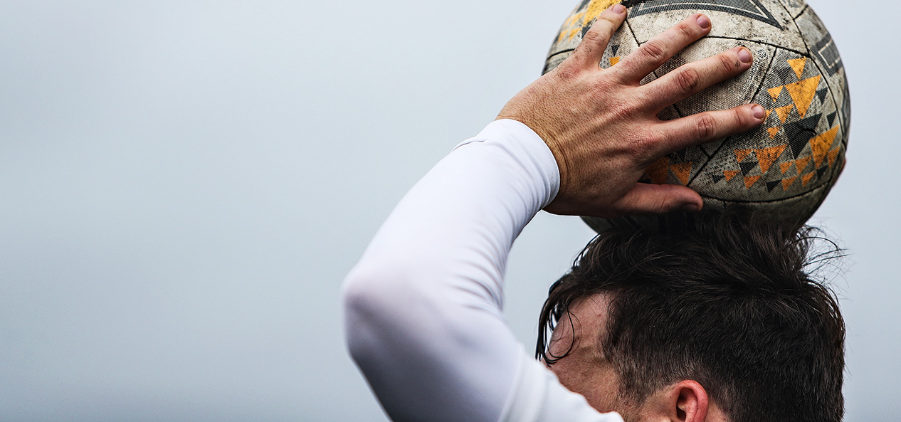 A close up of a footballer as they prepare to take a throw-in