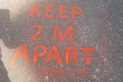 A social distancing message painted on the floor in a Rugby Borough Council park