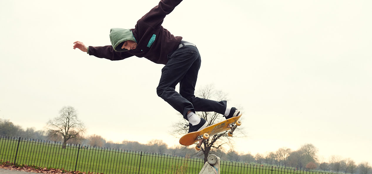 A skateboarder enjoying himself in a park