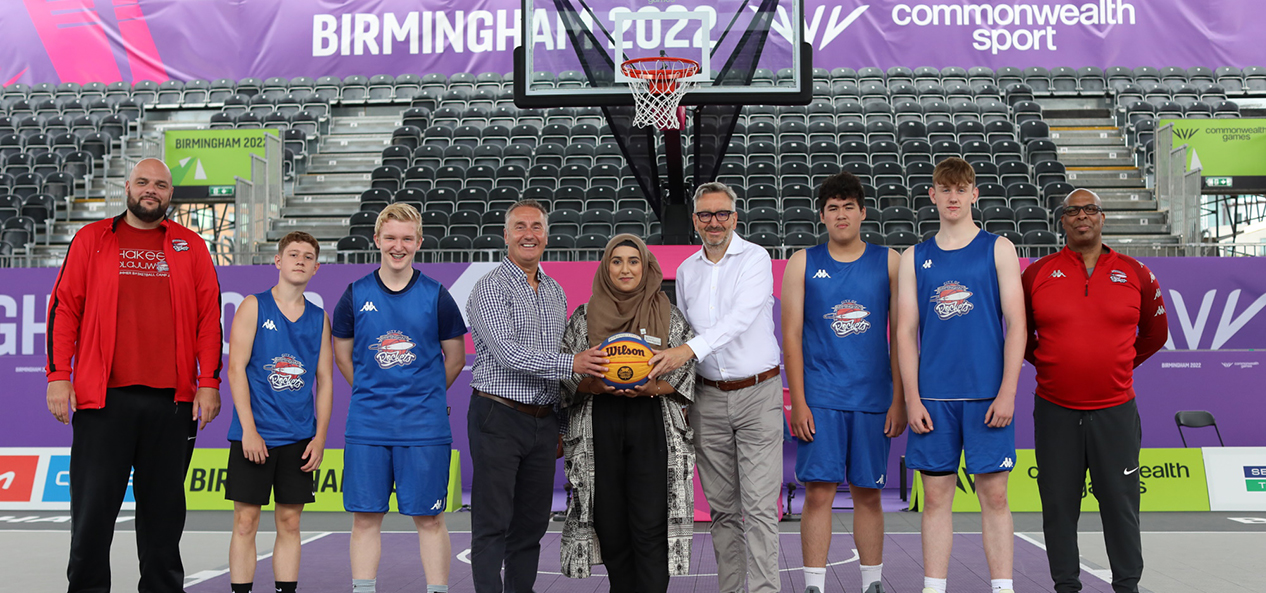 Sport England CEO Tim Hollingsworth poses on the 3x3 basketball court at Birmingham 2022 with a representatives of Basketball England, Birmingham City Councul and local basketball players