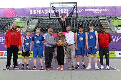 Sport England CEO Tim Hollingsworth poses on the 3x3 basketball court at Birmingham 2022 with a representatives of Basketball England, Birmingham City Councul and local basketball players