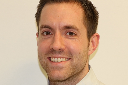 A headshot of Tom Burton, Sport England's national partnerships lead for health and inactivity