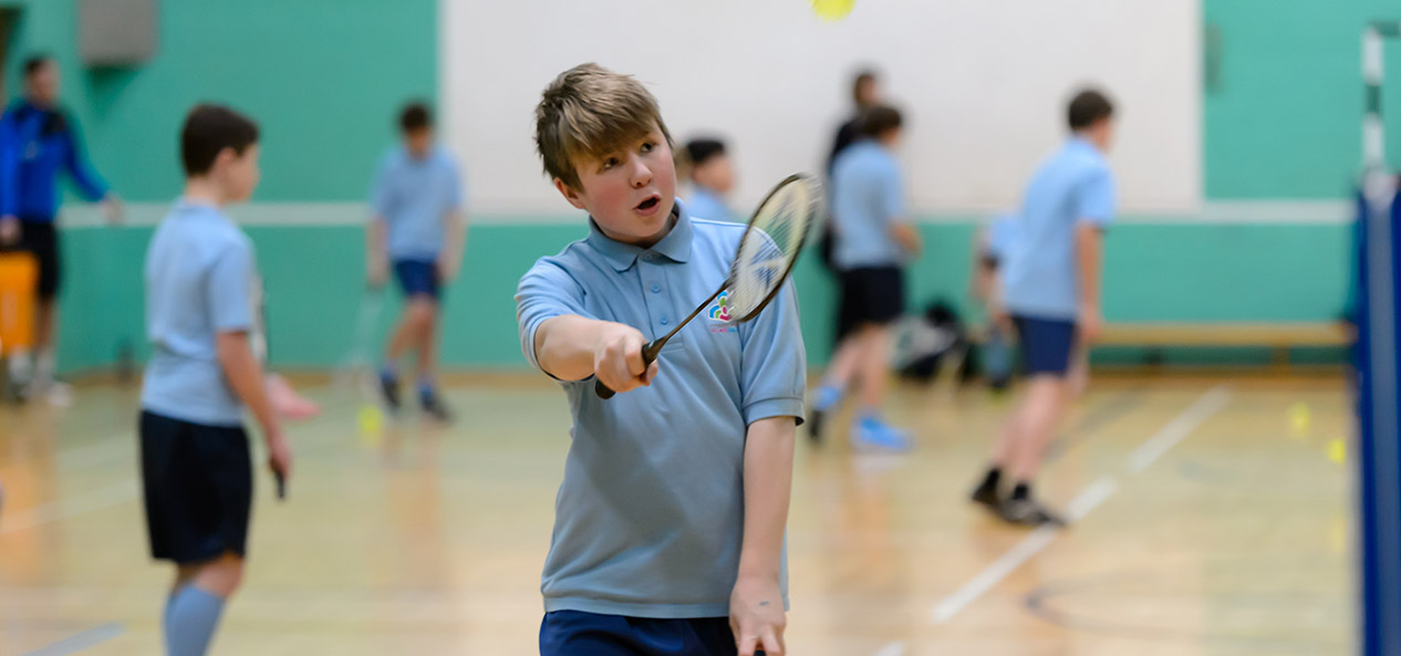 A boy plays badminton