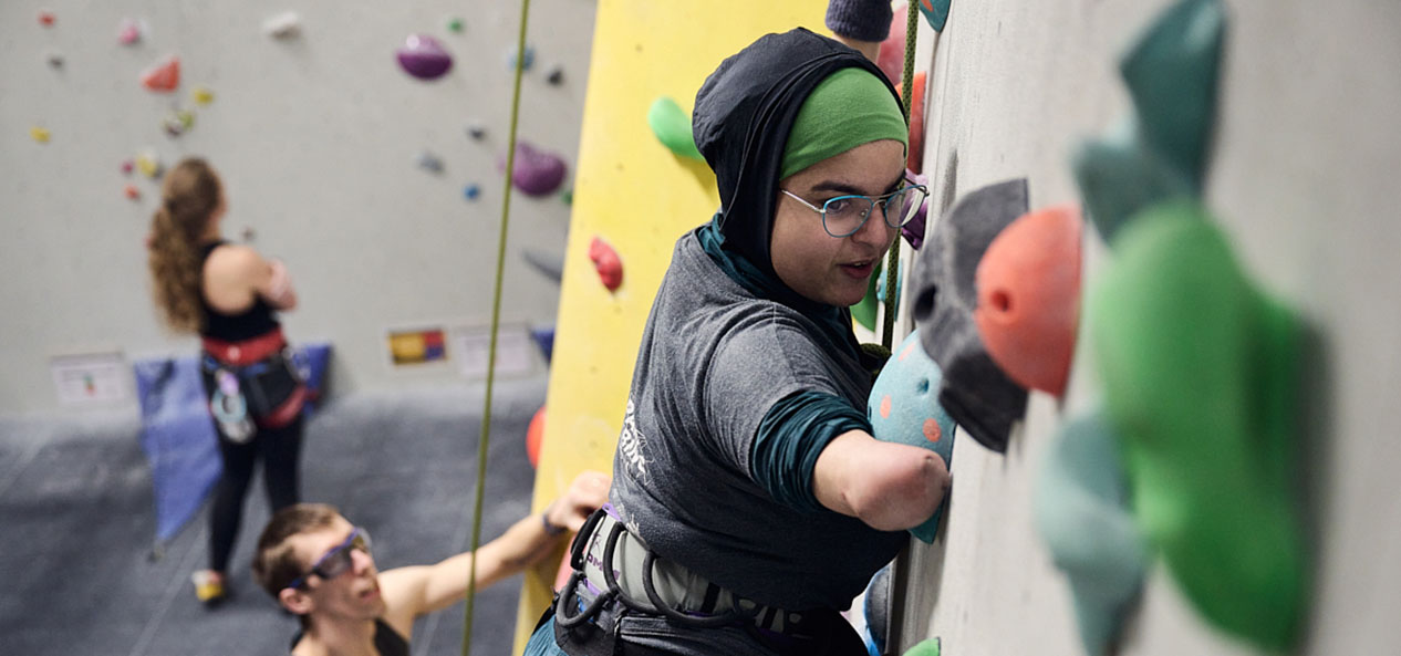 A woman using a climbing wall 