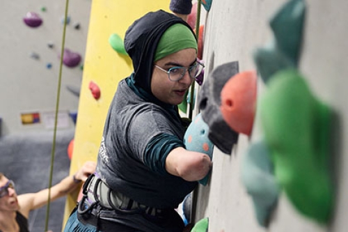 A woman using a climbing wall 