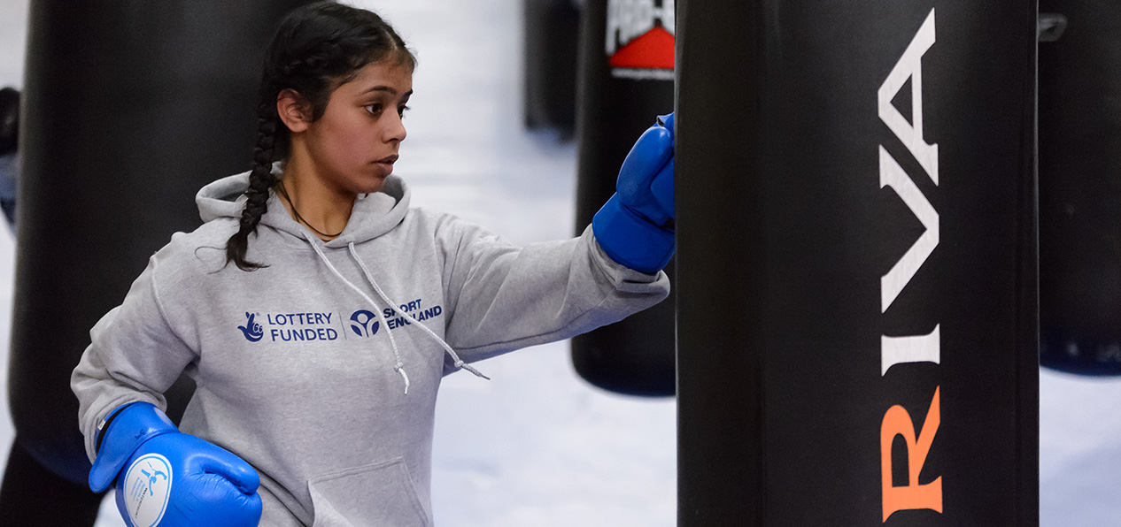 A woman hitting a punching bag.