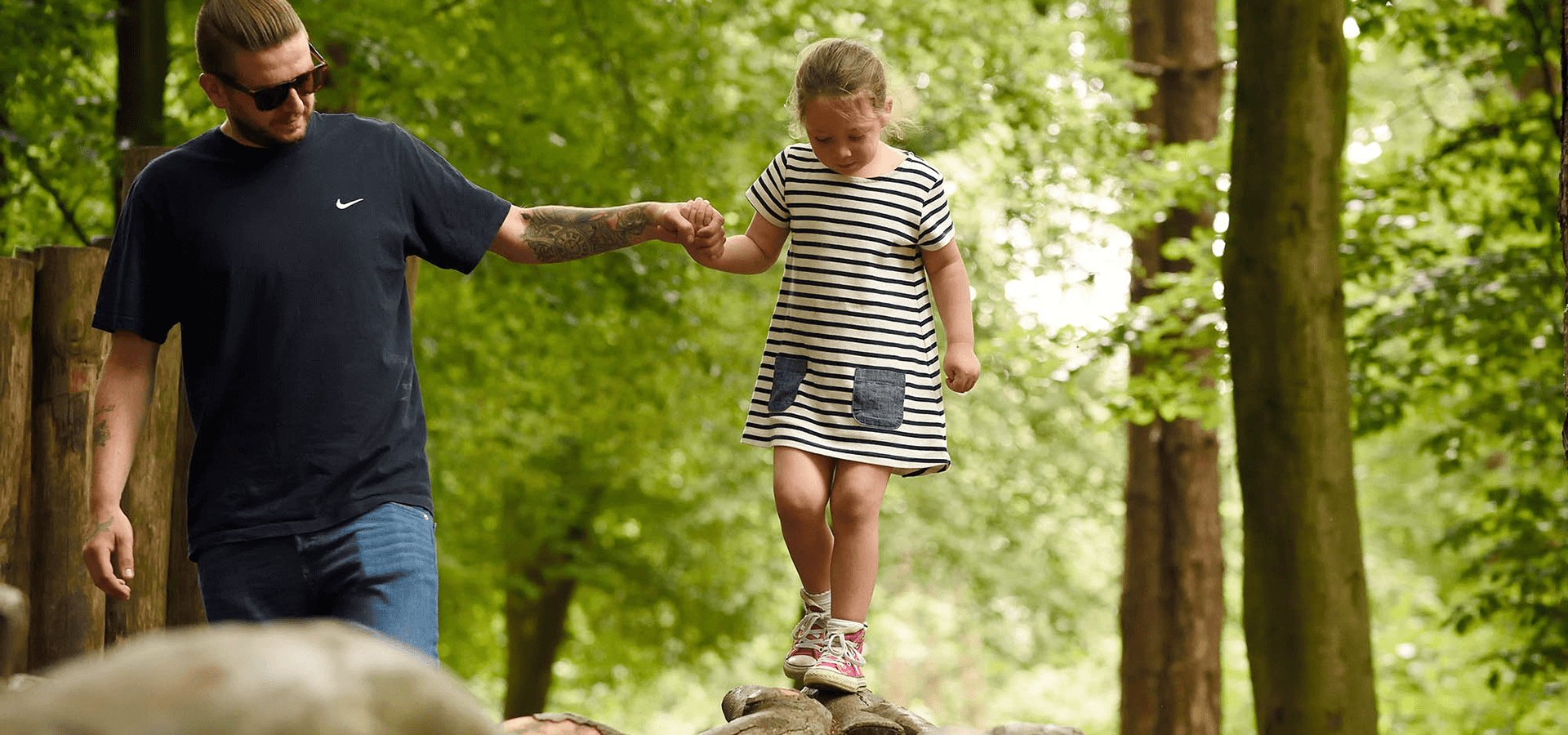 Father holding daughter's hand as she's walking