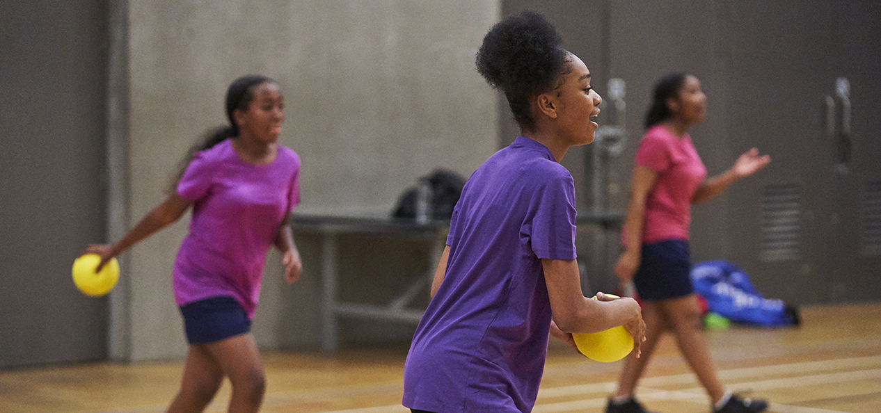 Group of girls playing ball games on a court