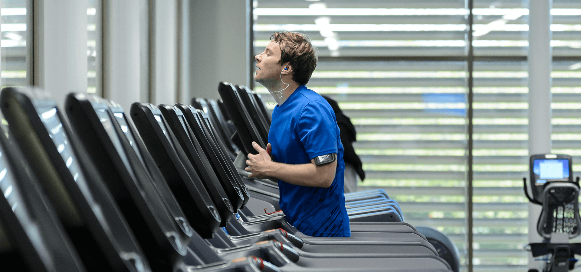 Man running on treadmill in gym