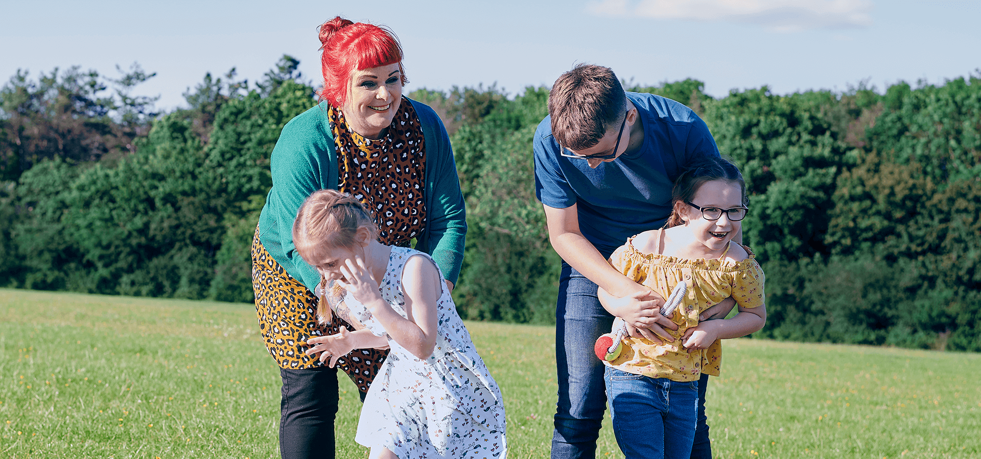 Parents playing with their children outdoors