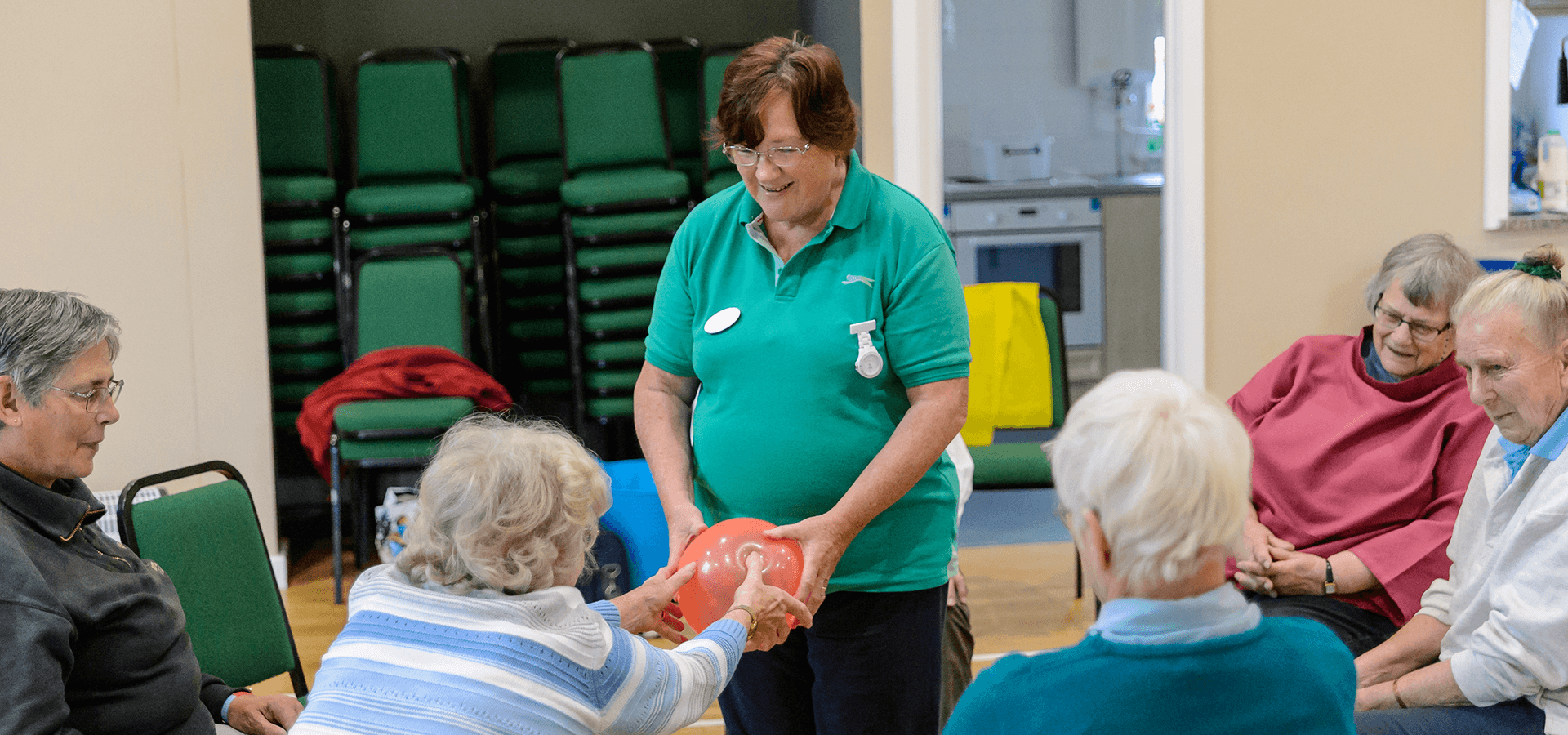 Volunteering group passing balloon