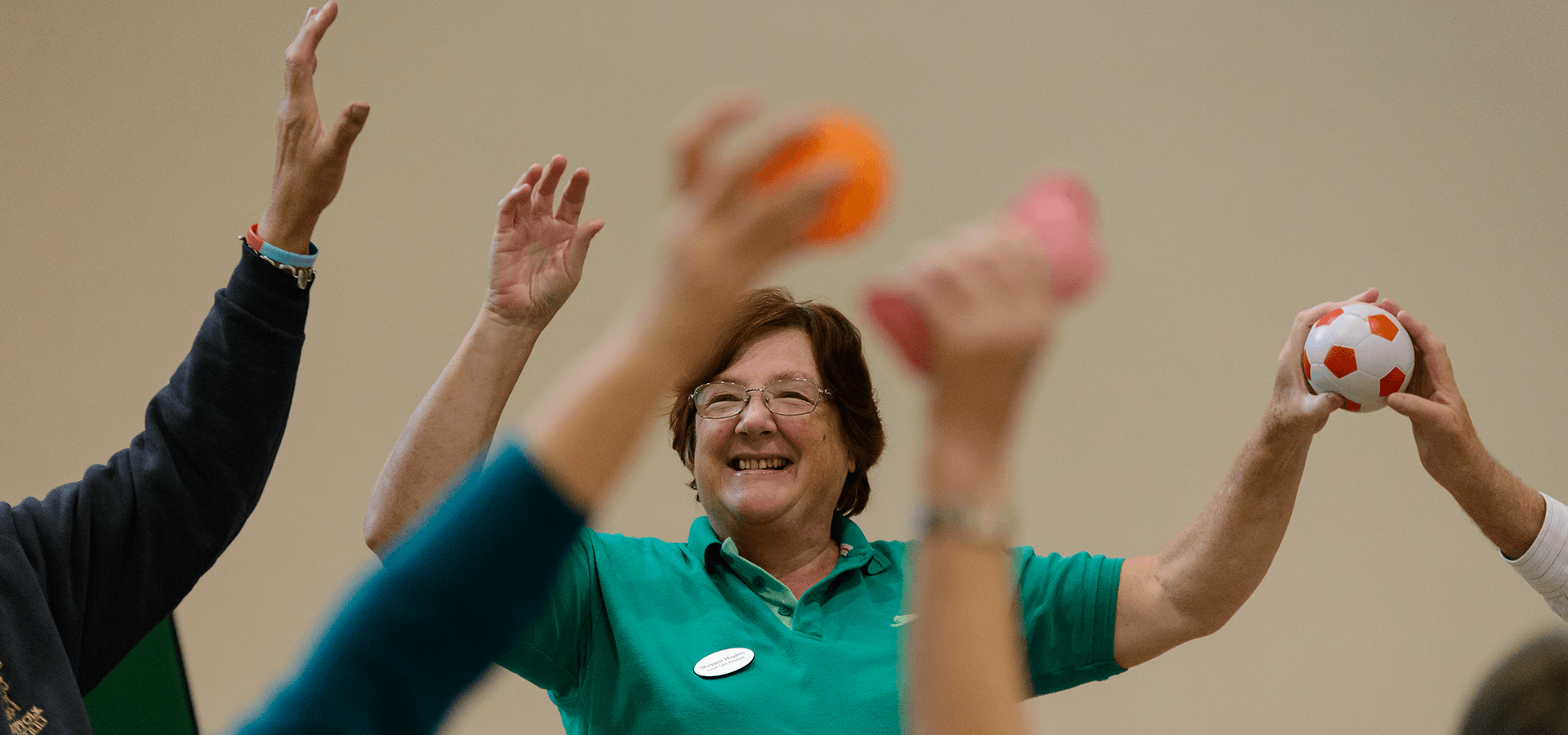 Exercise class with their arms in the air