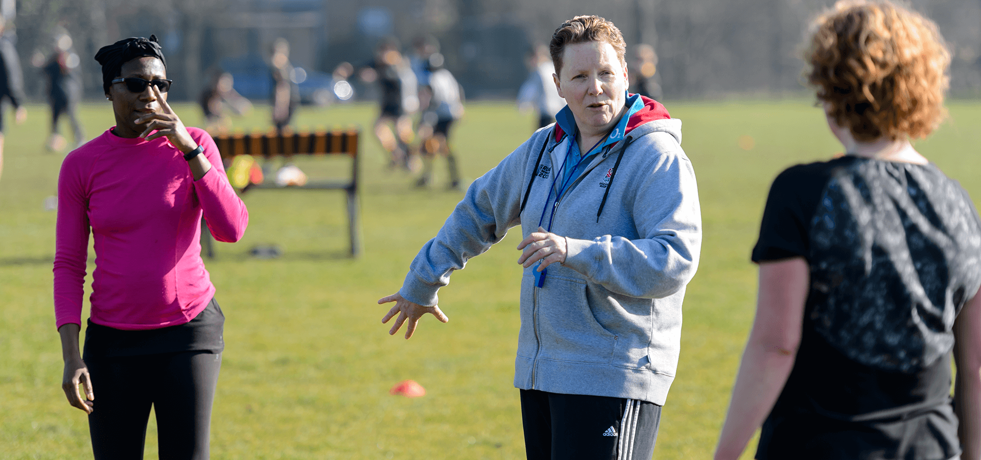 Coach instructs players on a field